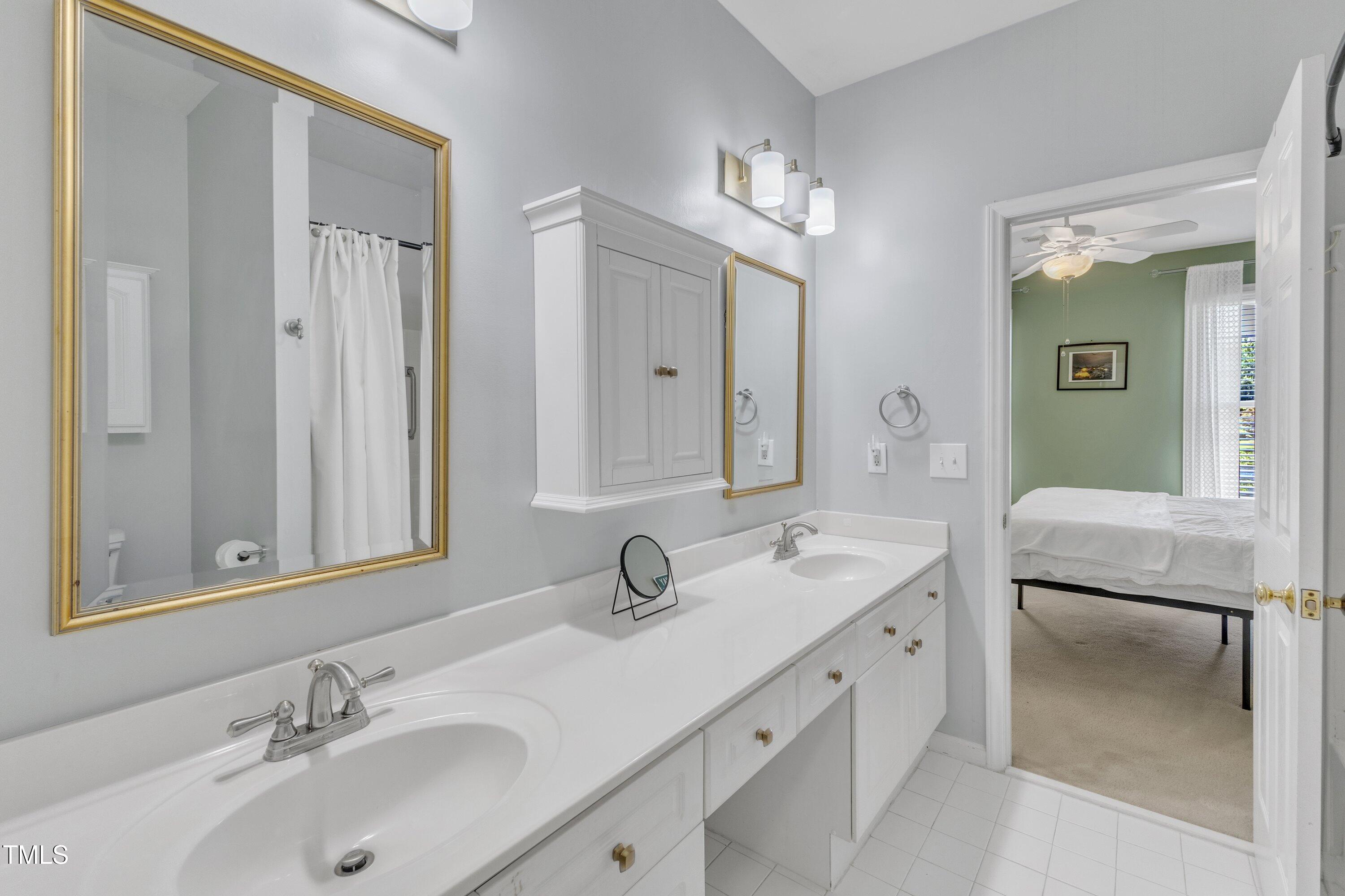 1201 Red Beech Court Raleigh, NC 27614 - Photo 22 of 41 Primary bathroom, with garden tub/shower, dual vanities, and walk in closet with drawers and shelving