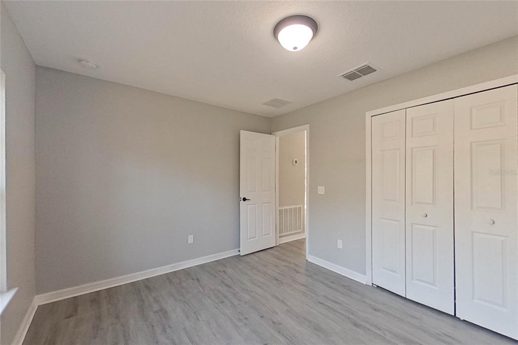 8806 Southwest 135th Street Road Ocala, FL 34473 - Photo 13 of 20 a view of an empty room and wooden floor