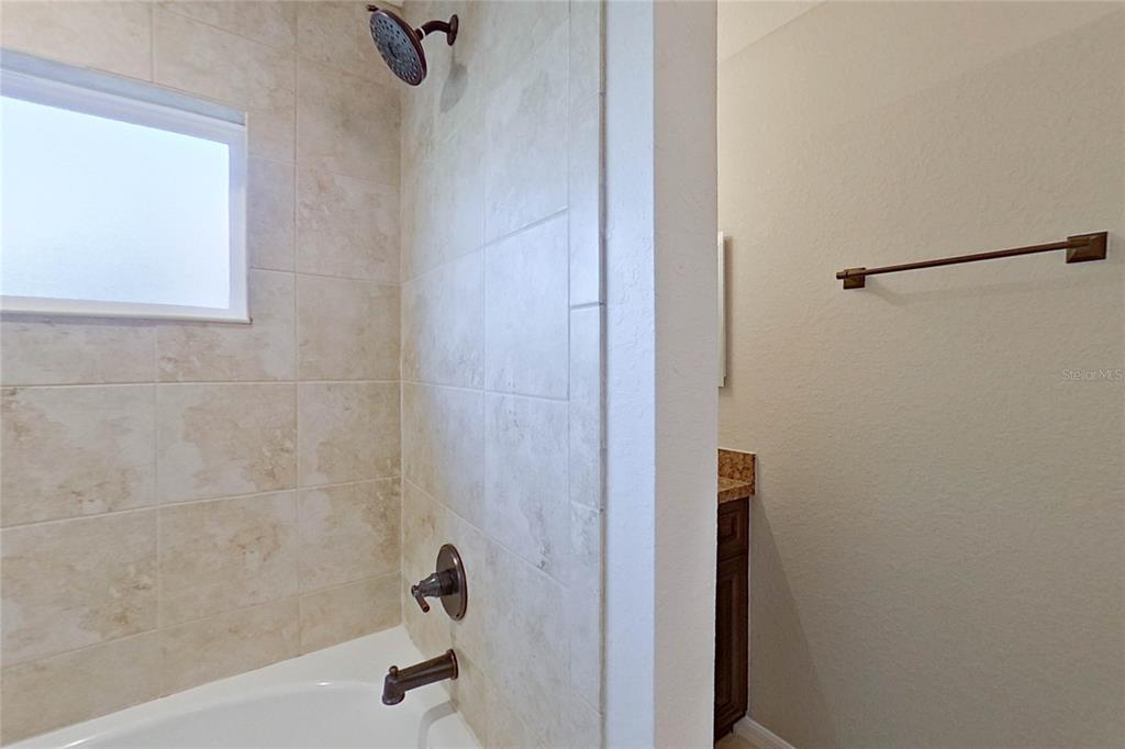 8806 Southwest 135th Street Road Ocala, FL 34473 - Photo 17 of 20 a bathroom with a shower and a bathtub
