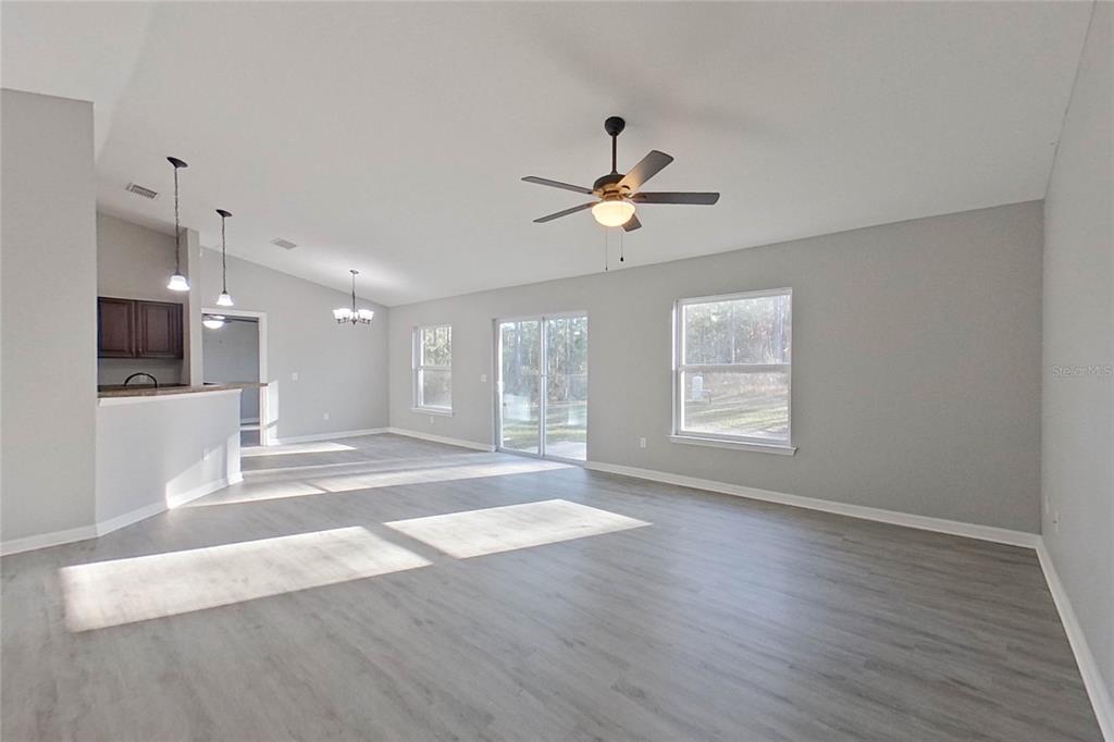 8806 Southwest 135th Street Road Ocala, FL 34473 - Photo 4 of 20 a view of an empty room with wooden floor and a window