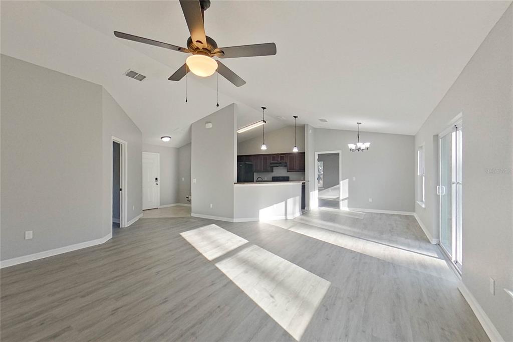 8806 Southwest 135th Street Road Ocala, FL 34473 - Photo 5 of 20 a view of an empty room with kitchen and a window