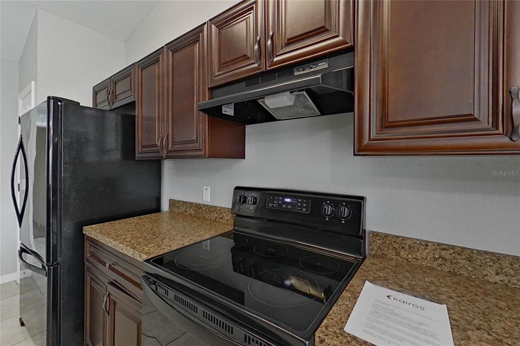 8806 Southwest 135th Street Road Ocala, FL 34473 - Photo 7 of 20 a kitchen with a stove and a refrigerator