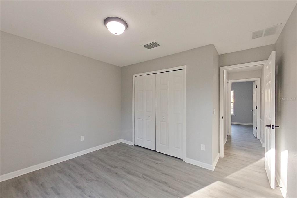 8806 Southwest 135th Street Road Ocala, FL 34473 - Photo 10 of 20 wooden floor in an empty room