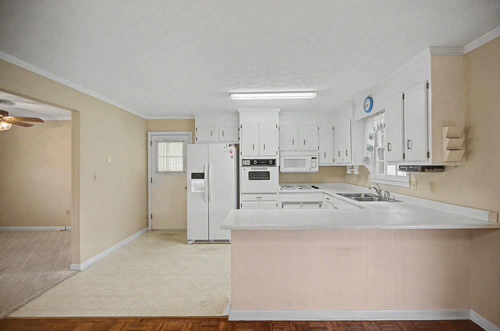 115 Brunson Drive Pickens, SC 29671 - Photo 5 of 29 White cabinetry and appliances create a clean, functional space, ideal for culinary creations.
