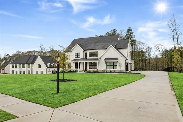 a front view of a house with a garden