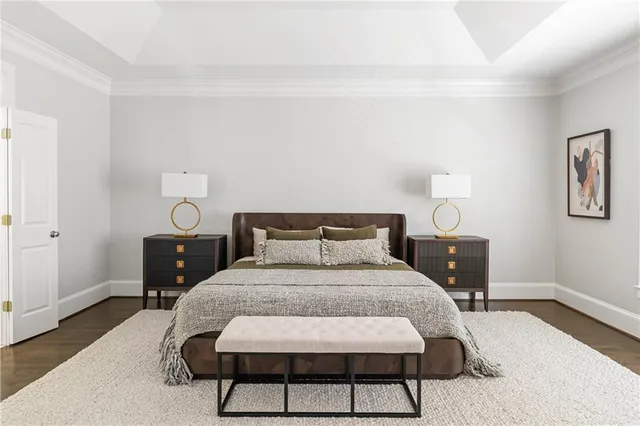 a bedroom with a bed a table and chair