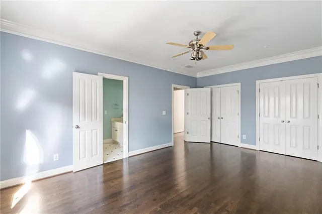 a view of a livingroom with wooden floor and a ceiling fan