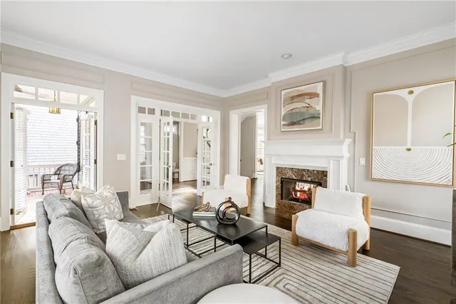 a living room with furniture fireplace and a large window