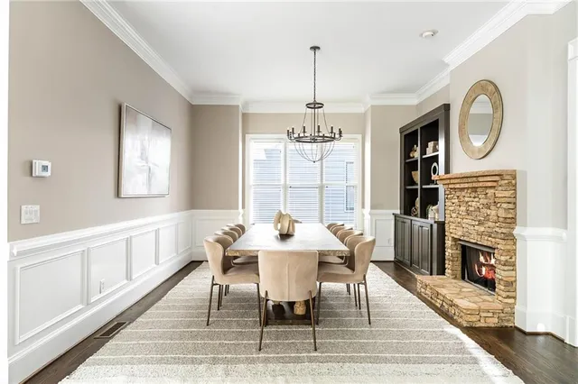 a view of a dining room with furniture a chandelier and wooden floor