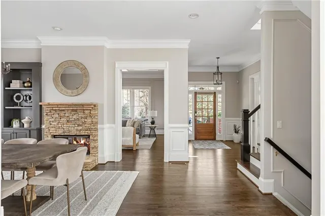 a living room with fireplace furniture and a wooden floor
