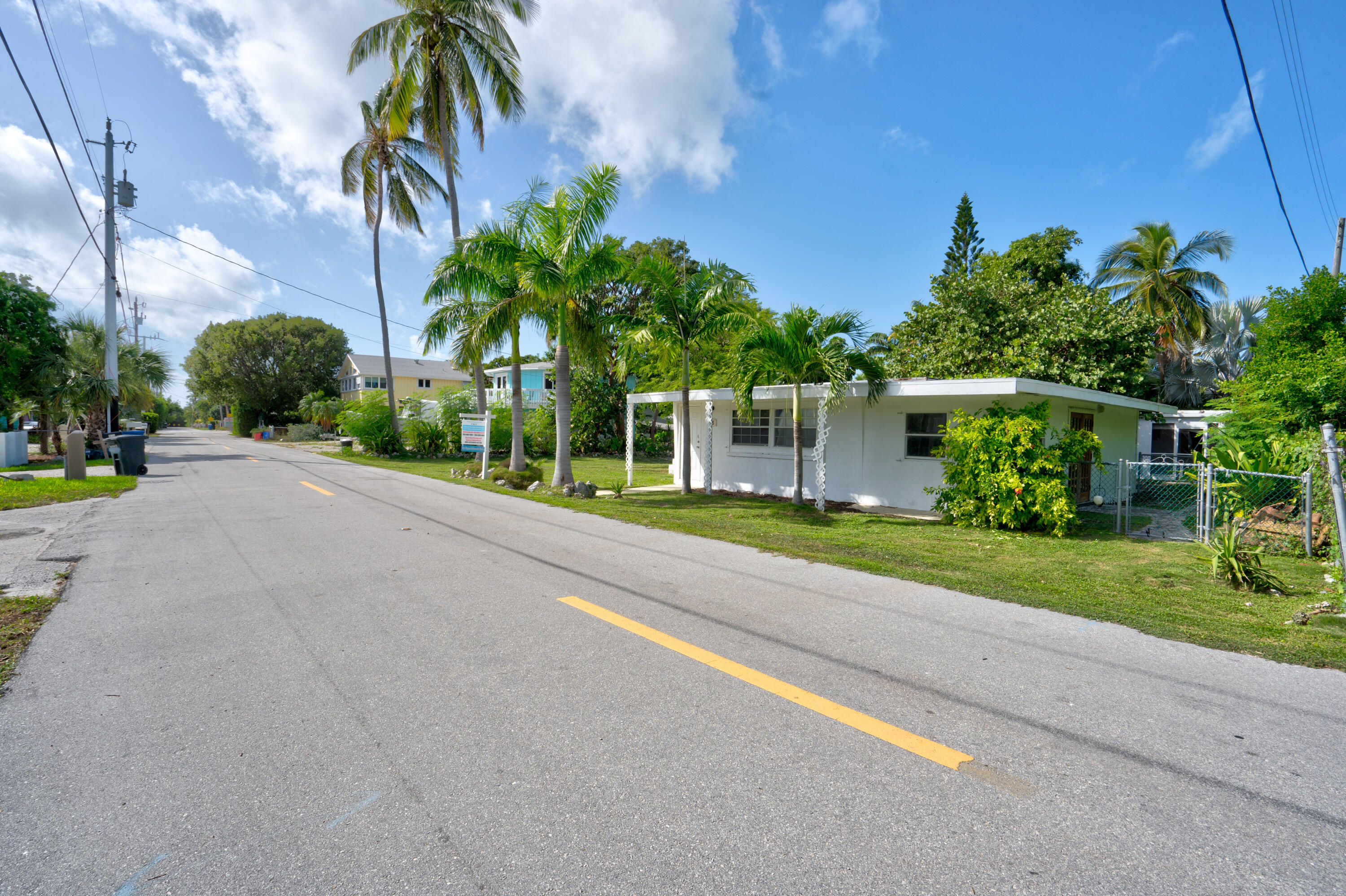 15 Seaside Avenue Key Largo, FL 33037 - Photo 38 of 55 a front view of a house with a yard and potted plants
