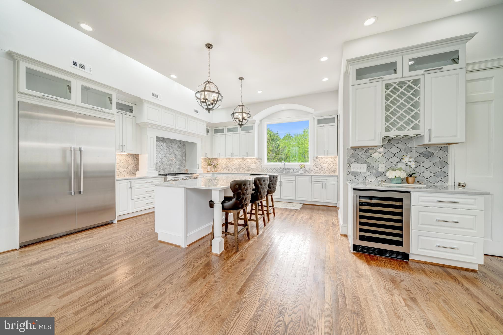 1111 Towlston Road McLean, VA 22102 - Photo 11 of 49 a kitchen with stainless steel appliances kitchen island hardwood floor and a sink