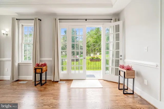 a living room filled with furniture and a floor to ceiling window