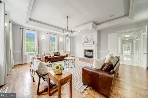 a living room with furniture wooden floor and a fireplace