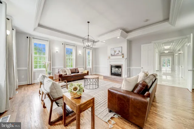 a living room with furniture wooden floor and a fireplace