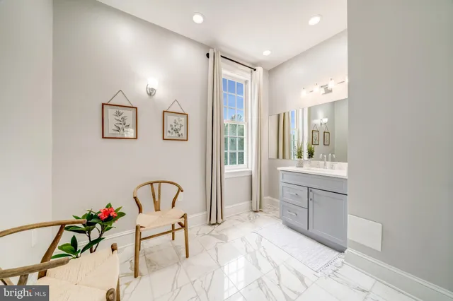 a spacious bathroom with a granite countertop tub sink and mirror