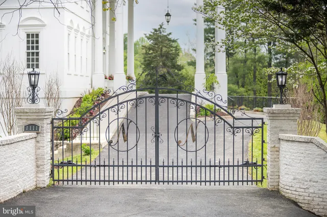 a white building with a trees in the background