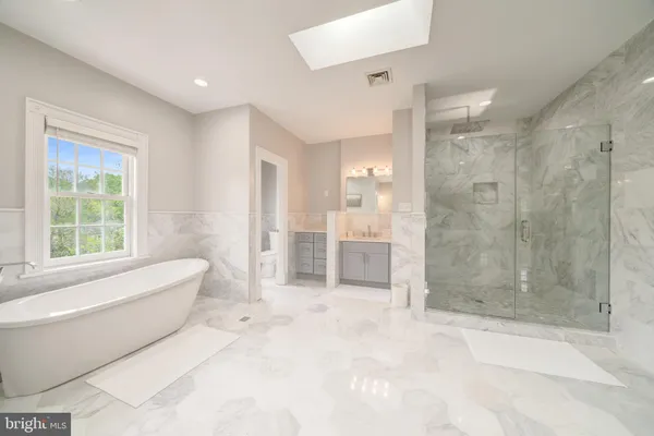 a spacious bathroom with a shower tub and shower