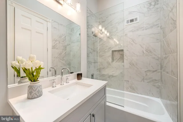 a bathroom with a sink a vanity and a bathtub