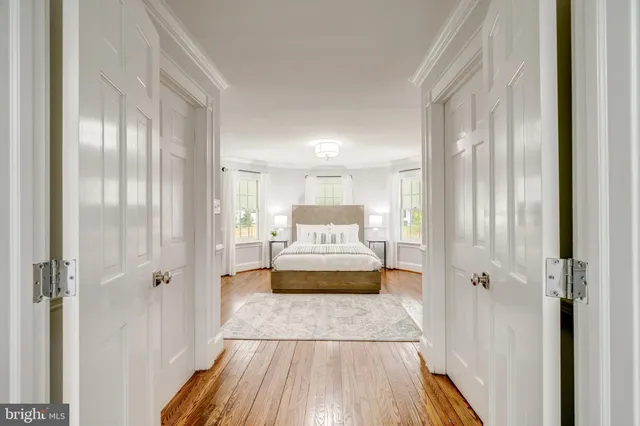 a spacious bedroom with a bed and a mirror