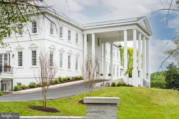 a front view of a house with a garden and plants