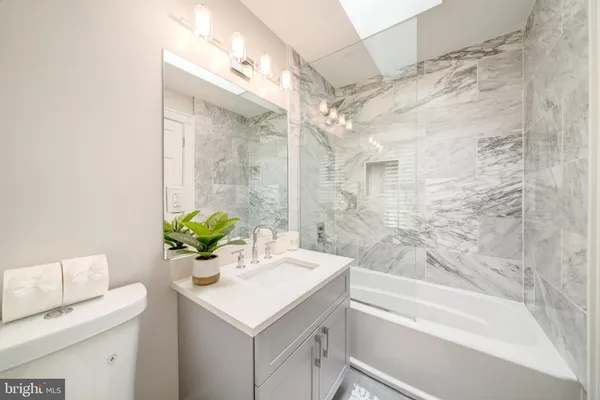 a bathroom with a sink a toilet and a bathtub