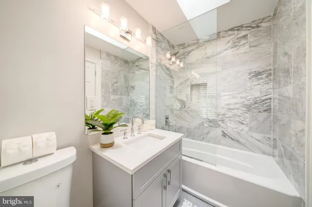 a bathroom with a sink a toilet and a bathtub