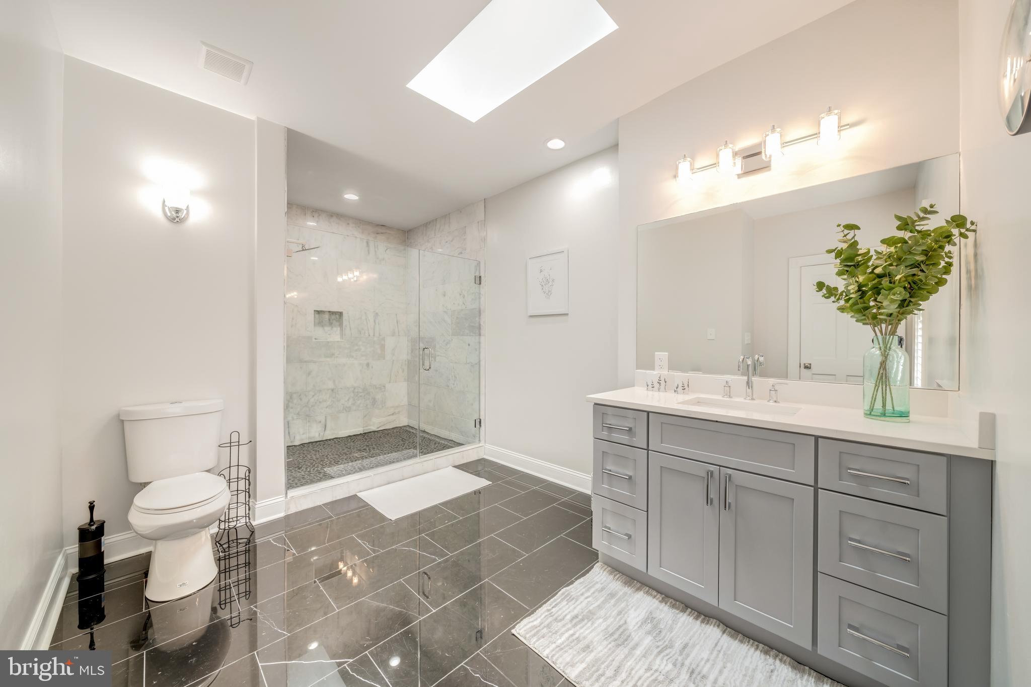 1111 Towlston Road McLean, VA 22102 - Photo 36 of 49 a spacious bathroom with a shower sink mirror and toilet