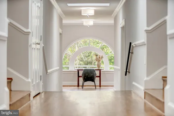 a view of an entryway with wooden floor door