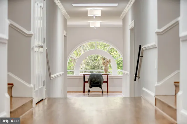 a view of an entryway with wooden floor door