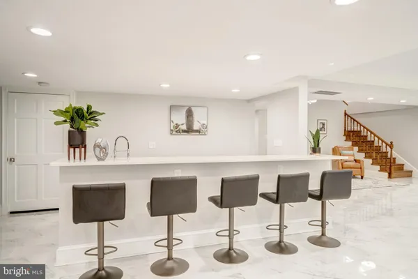 a kitchen with stainless steel appliances kitchen island granite countertop a table and chairs in it