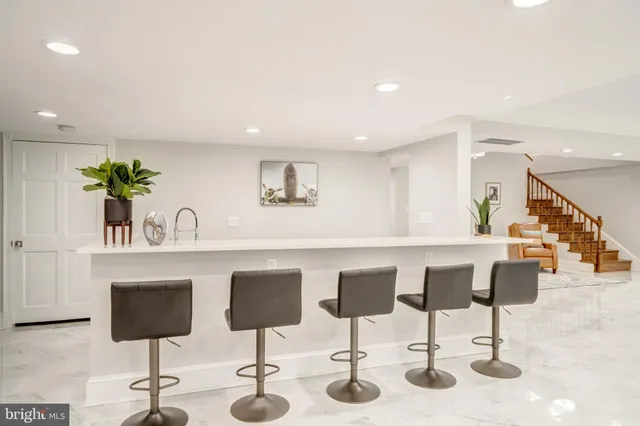 a kitchen with stainless steel appliances kitchen island granite countertop a table and chairs in it