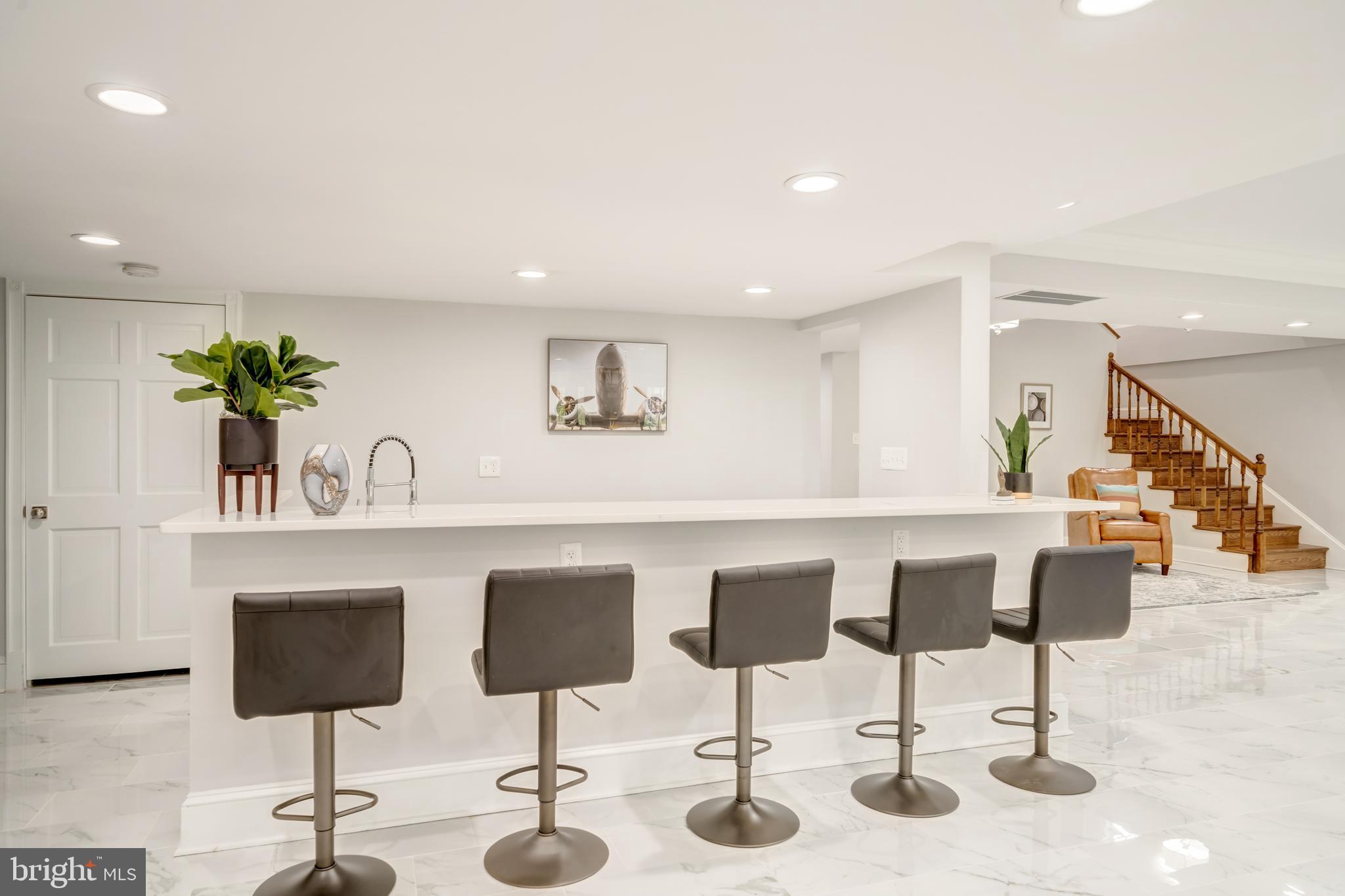 1111 Towlston Road McLean, VA 22102 - Photo 39 of 49 a kitchen with stainless steel appliances kitchen island granite countertop a table and chairs in it