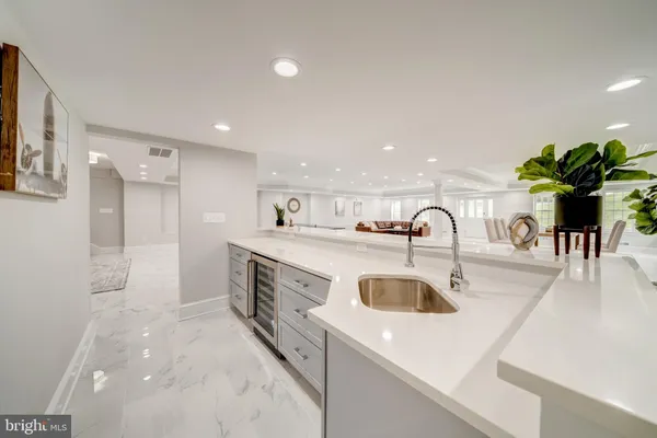 a kitchen with sink a refrigerator and stove
