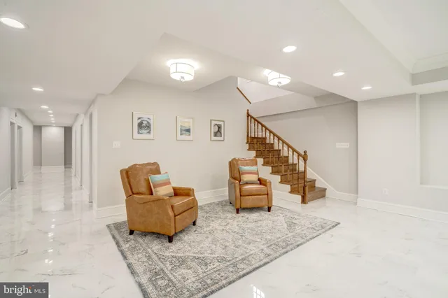 a living room with furniture and stairs