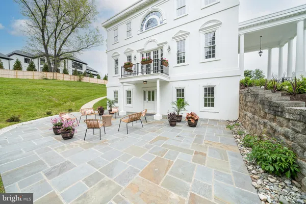 a view of a house with backyard sitting area and garden