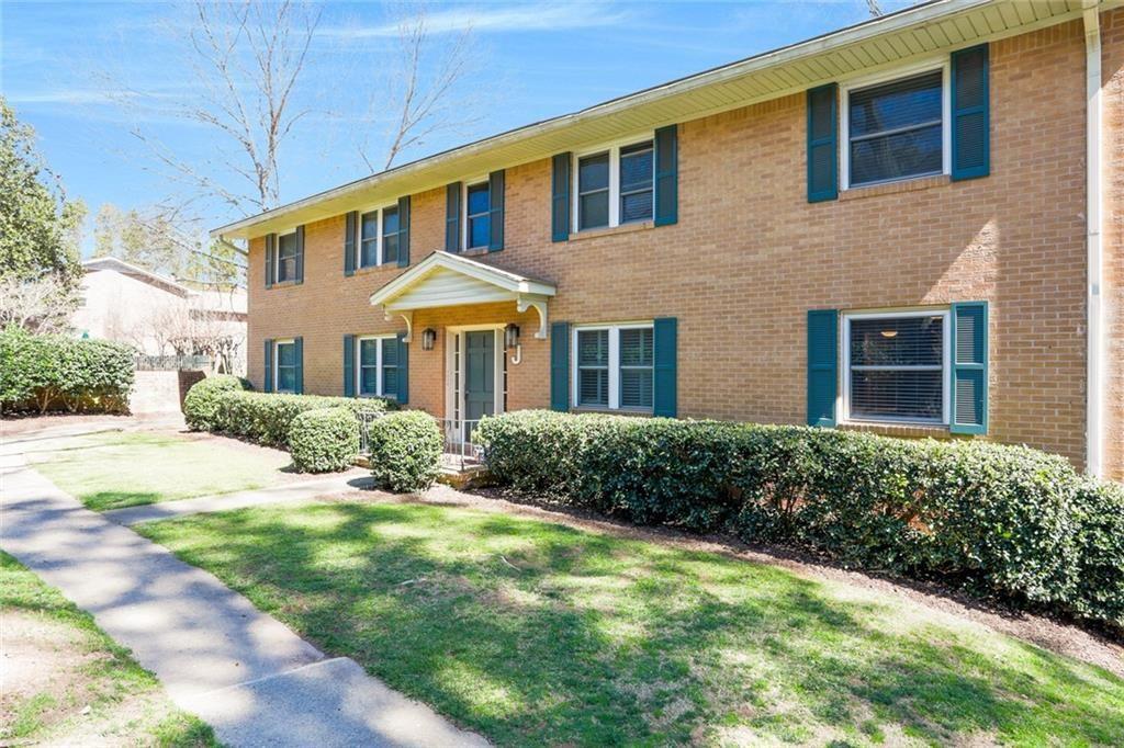 a front view of a house with yard and green space