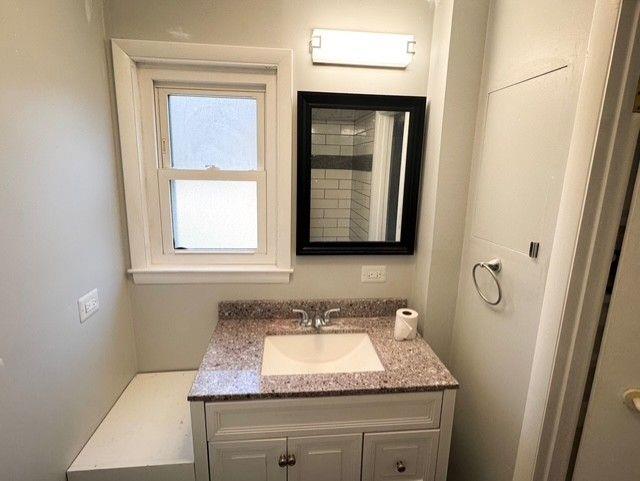 3510 Roswell Road Northwest, Unit J3 Atlanta, GA 30305 - Photo 14 of 17 a bathroom with a granite countertop sink and a mirror