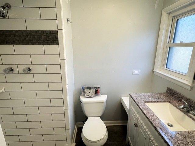 3510 Roswell Road Northwest, Unit J3 Atlanta, GA 30305 - Photo 16 of 17 a bathroom with a granite countertop toilet sink and mirror