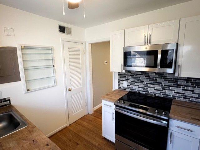 3510 Roswell Road Northwest, Unit J3 Atlanta, GA 30305 - Photo 5 of 17 a kitchen with a stove and a microwave
