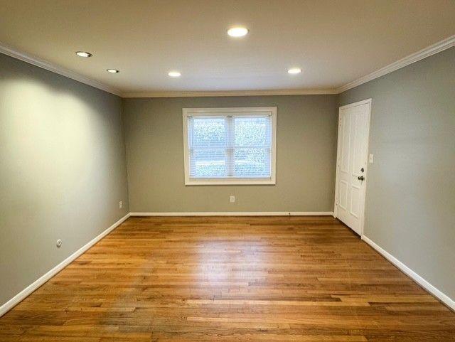 3510 Roswell Road Northwest, Unit J3 Atlanta, GA 30305 - Photo 7 of 17 an empty room with wooden floor and windows