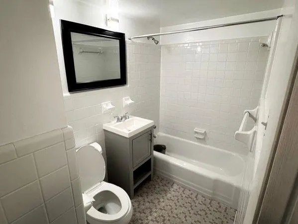 a bathroom with a toilet sink and mirror or bathtub