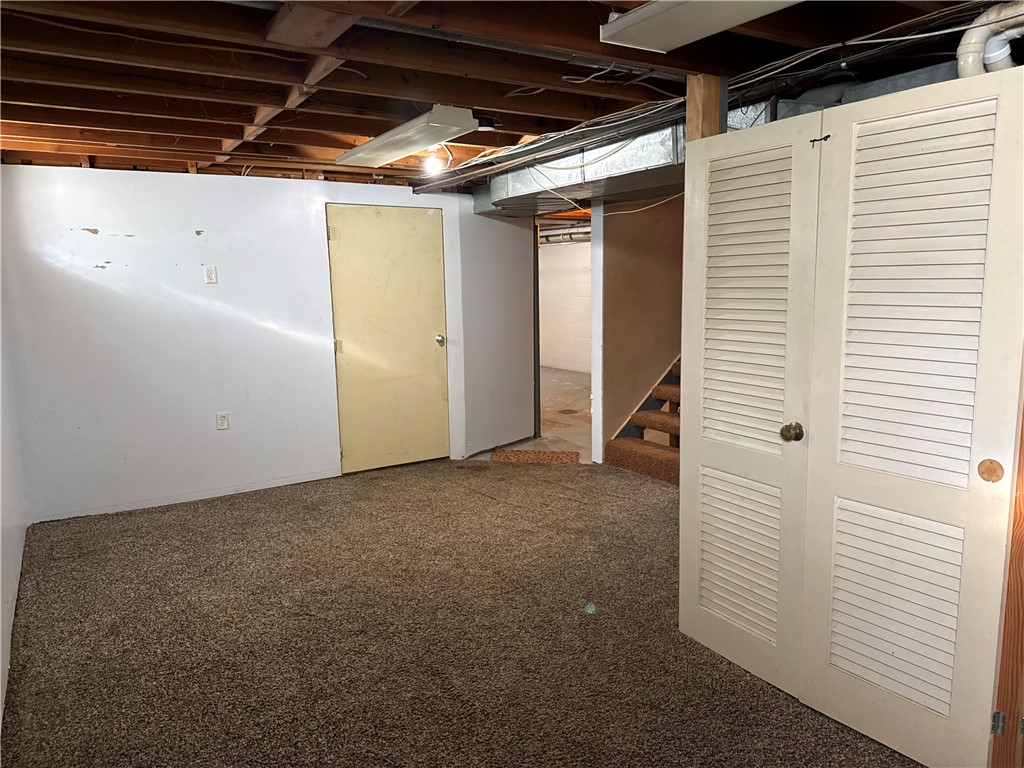 4732 Lehigh Drive Springfield, OH 45503 - Photo 18 of 27 This versatile basement space features exposed ceiling beams and durable carpeting, offering endless possibilities.