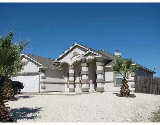 a view of a house with a yard and garage