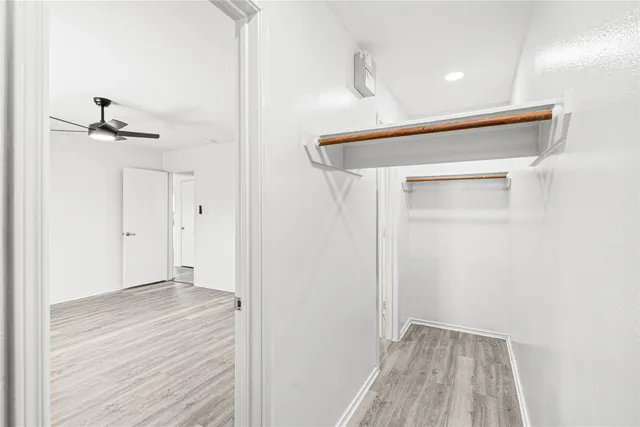 a view of a hallway with wooden floor