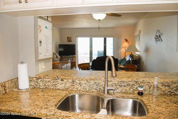 a kitchen with a sink and a refrigerator