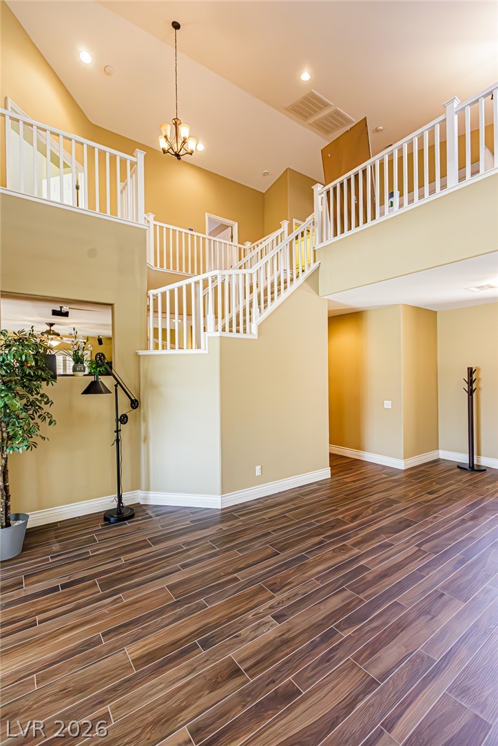 75 Tall Ruff Drive Las Vegas, NV 89148 - Photo 8 of 64 Soaring ceilings and rich wood floors frame a grand, split-level staircase design.
