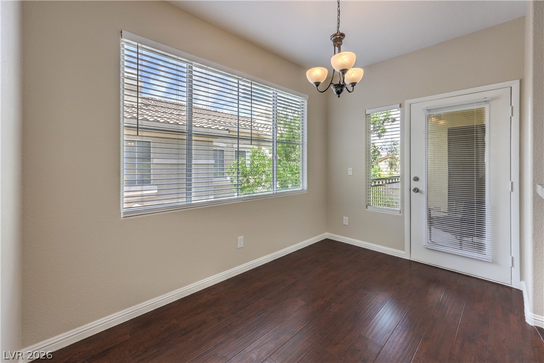 9050 West Warm Springs Road, Unit 2033 Las Vegas, NV 89148 - Photo 15 of 30 Rich hardwood flooring complements a chic light fixture in this inviting dining area.