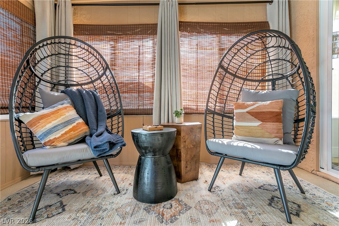 101 Beaver Ridge Avenue North Las Vegas, NV 89031 - Photo 29 of 42 Comfortable seating area with woven window treatments and patterned flooring.