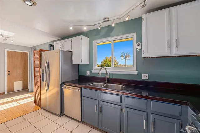 a kitchen with stainless steel appliances a refrigerator sink and cabinets
